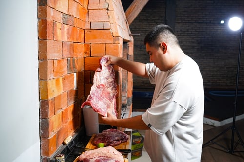 Chef Richard preparing vacio beef at Fluido's Asado.