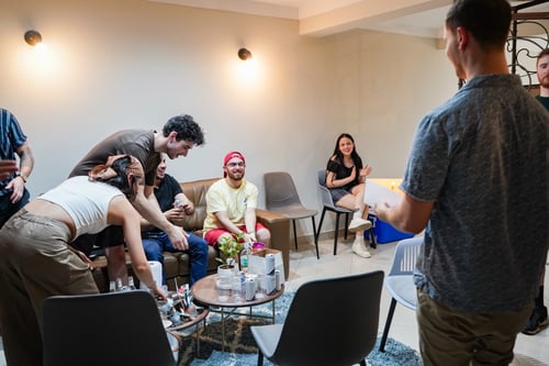 Teacher Raúl celebrating is birthday at Fluido, Sam brining him a cake.
