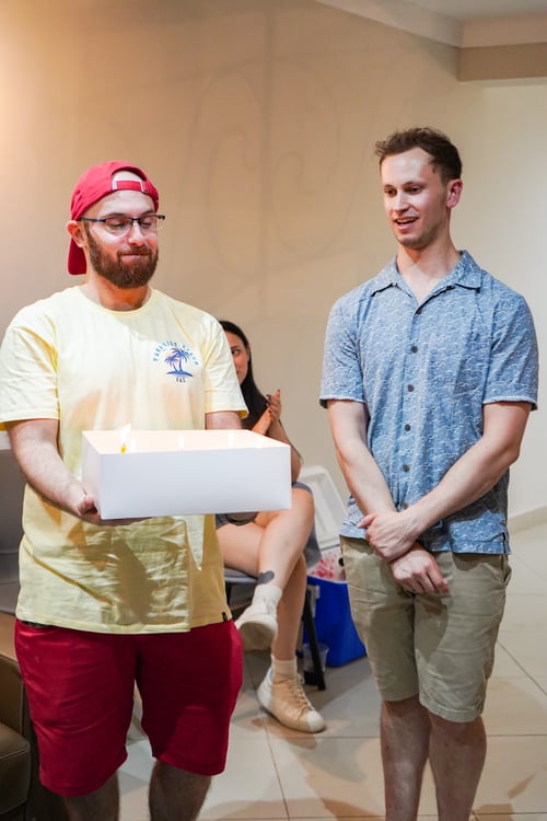 Sam and Raúl standing with his birthday cake