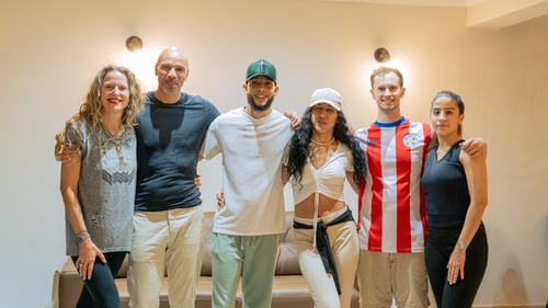 students posting for a group photo after Fluido's salsa class