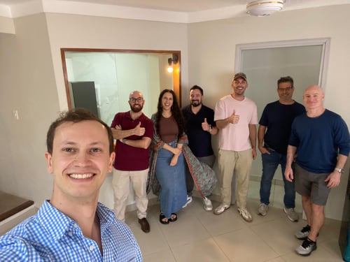 Selfie of Sam with students and teachers